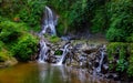 Waterfall landscape. Beautiful hidden Pengibul waterfall in rainforest. Tropical scenery. Water reflection. Slow shutter speed, Royalty Free Stock Photo