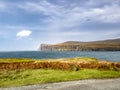 Waterfall on the left stopped and reversed by autumn storm Callum on the cliffs seen from Lower Milovaig - Isle of Skye Royalty Free Stock Photo