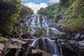 Waterfall located in the forest of Thailand. The water flows over a rocky cliff into a pool. Royalty Free Stock Photo