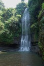 A waterfall located in the middle of a forest in the mountains of Cimahi City Royalty Free Stock Photo