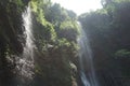 A waterfall located in the middle of a forest in the mountains of Cimahi City Royalty Free Stock Photo