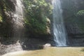 A waterfall located in the middle of a forest in the mountains of Cimahi City Royalty Free Stock Photo