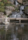 Waterfall long exposure silky smooth waterfall over rocky cliffs in Kyoto garden Royalty Free Stock Photo