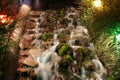 A waterfall on a minuature golf course at night