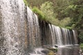 Waterfall in mountain lake and green park in Rascafria. Royalty Free Stock Photo
