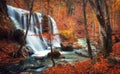 Waterfall at mountain river in autumn forest at sunset. Royalty Free Stock Photo