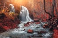 Waterfall at mountain river in autumn forest at sunset