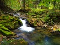 Waterfall on mountain river with moss on rocks Royalty Free Stock Photo