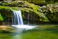 Waterfall on mountain river rushing through canyon Royalty Free Stock Photo