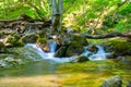 Waterfall on mountain river rushing through canyon Royalty Free Stock Photo