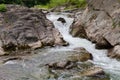 Waterfall on the mountain river at spring overcast evening Royalty Free Stock Photo