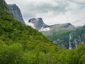 Waterfall and mountains near briksdalsbreen Glacier in Norway Royalty Free Stock Photo