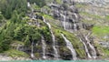 Waterfall in the mountains near lake. Oeschinnensee. Kandertal. Bernese Oberland. Canton Bern.