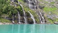 Waterfall in the mountains near lake. Oeschinnensee. Kandertal. Bernese Oberland. Canton Bern.