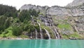 Waterfall in the mountains near lake. Oeschinnensee. Kandertal. Bernese Oberland. Canton Bern.