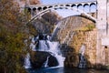 Waterfall near a huge wall