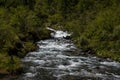 The waterfall noisily rushes down from the high mountains of Altai Royalty Free Stock Photo