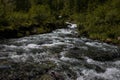 The waterfall noisily rushes down from the high mountains of Altai Royalty Free Stock Photo