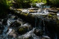 The waterfall noisily rushes down from the high mountains of Altai