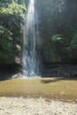 A waterfall located in the middle of a forest in the mountains of Cimahi City Royalty Free Stock Photo
