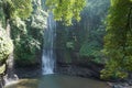 A waterfall located in the middle of a forest in the mountains of Cimahi City Royalty Free Stock Photo