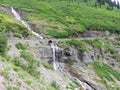 Waterfall through old rock bridge, along Going to the sun road in Glacier National Park Montana USA Royalty Free Stock Photo