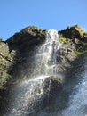 Waterfall over mossy rocks Royalty Free Stock Photo