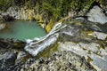 Waterfall over rocks moss verdure boxwood in the jungle