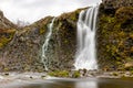 Waterfall and pond surrounded by basalt columns, Gjain Canyon in Thjorsardalur valley, Iceland Royalty Free Stock Photo