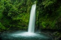 Waterfall at rain forest tropical rocky river surrounded by plants and valley Royalty Free Stock Photo