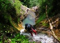 Rappelling on forest waterfall