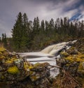 Waterfall on the river in boreal, norwegian forest. Autumn time. Royalty Free Stock Photo