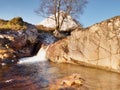 Waterfall on river Coupall at delta to river Etive. Snowy mountain Stob Dearg 1021 metres high