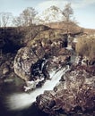 Waterfall on river Coupall at delta to river Etive. Snowy mountain Stob Dearg 1021 metres high