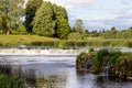 Waterfall in the river, trees and sky, summer Royalty Free Stock Photo