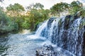 Waterfall and river with water running over the rocks and betweem the tropical forest Royalty Free Stock Photo