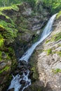 A waterfall within rocks and grass