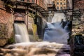 Waterfall running through buildings. Long esposure