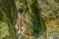 the waterfall is running down the mountainside into the valley Royalty Free Stock Photo