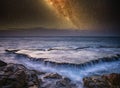 Waterfall in sea and milky way