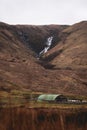 Waterfall with the shelter for sheep in front