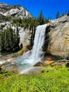 Waterfall with a small rainbow on a sunny day