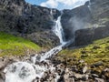 Waterfall and stream flowing on mountainside Royalty Free Stock Photo