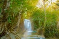 Waterfall with sun ray in tropical deep forest at Erawan National Park Royalty Free Stock Photo