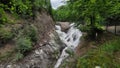 Waterfall surrounded by lush vegetation