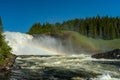 The waterfall Tannforsen in northern Sweden with a rainbow in the mist
