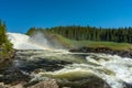 The waterfall Tannforsen in Sweden with a rainbow in the mist