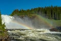 The waterfall Tannforsen in Sweden with rainbows in the mist Royalty Free Stock Photo