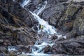 Waterfall in Tatra Mountains. Tourist standing in front of Siklawa Waterfall.