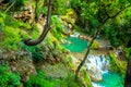 Waterfall in tropical green tree forest. Waterfall is flowing in jungle Royalty Free Stock Photo